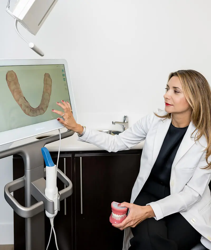 Dr. Negar Eslami speaking with a patient at Downtown Dental Design in Austin TX