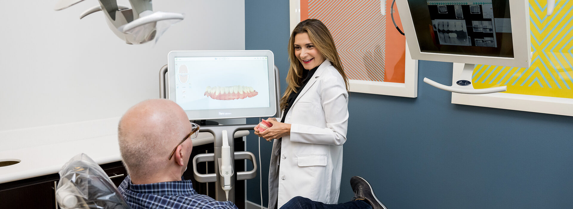 Dr. Eslami discussing dental care with a patient at Downtown Dental Design in Austin, TX